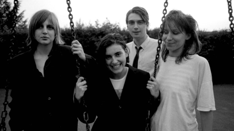 Elastica. Group portrait of British band  posing on a swing before a show at Bedford Esquires, Bedford, United Kingdom, 5th June 1993. L-R Donna Matthews, Justine Frischmann, Justin Welch, Annie Holland. (by Andy Willsher/Redferns)